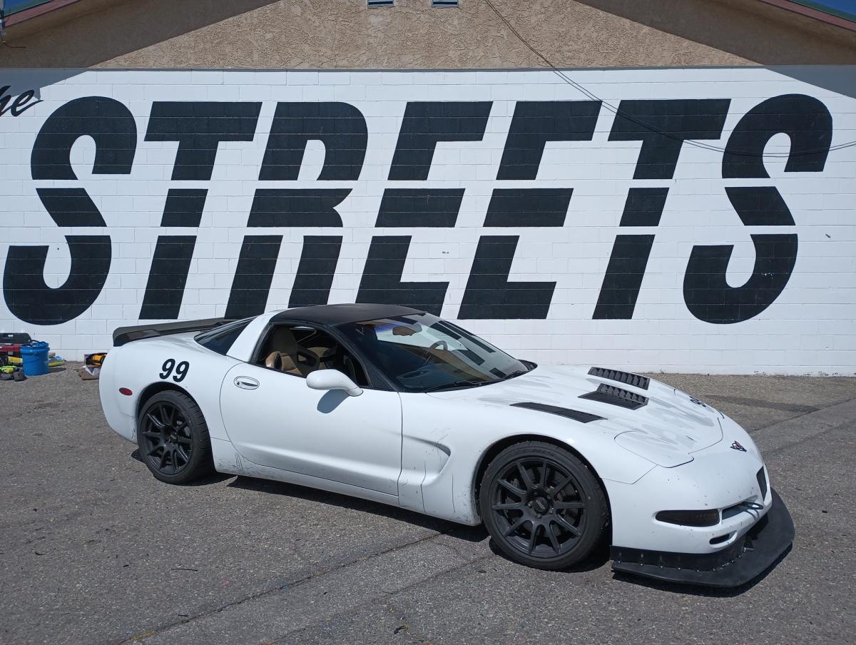 C5 Corvette with Cadillac Brembos posing in front of the Streets of Willow sign.