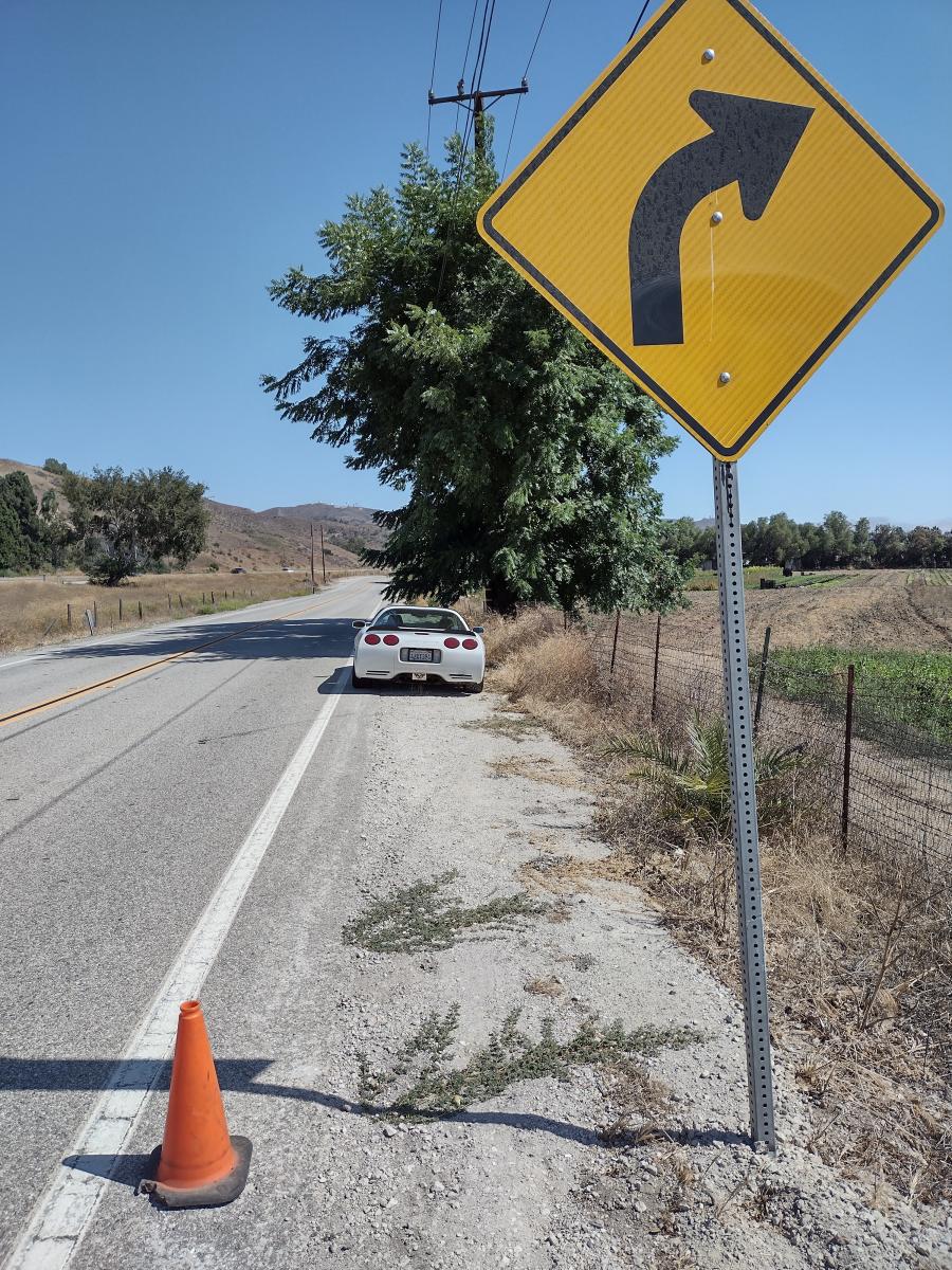 C5 Corvette on a barren back road where brake testing was conducted to check distance and temperatures