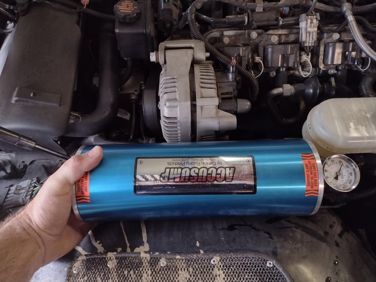 An Accusump test fit where the windshield washer fluid reservoir would normally go on a C5 Corvette.