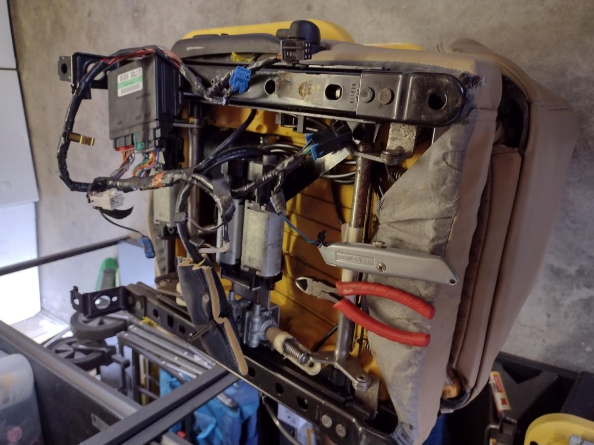 An underneath view of the Base C5 Corvette Seat. The control box is in the process of being removed.