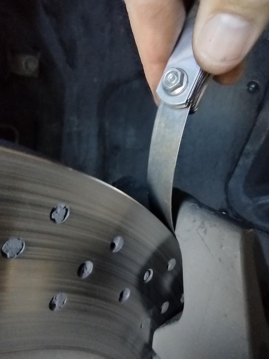 C5 Cadillac Brembo non-ground Caliper clearance demonstration with a thin feeler gauge