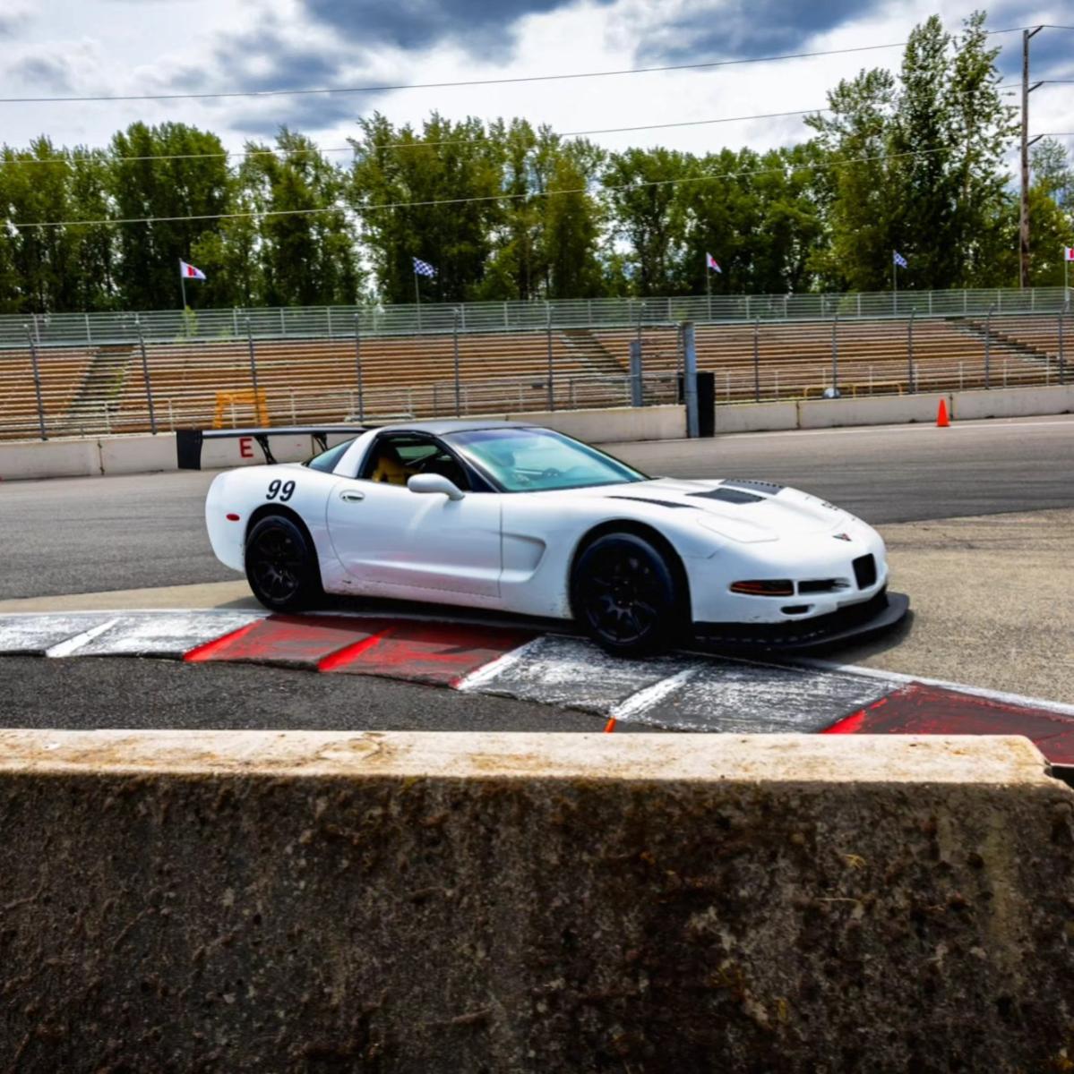 1999 C5 Corvette Targa Top taking Turn 1 (Chicane) at PIR just barely touching the rumble strips.