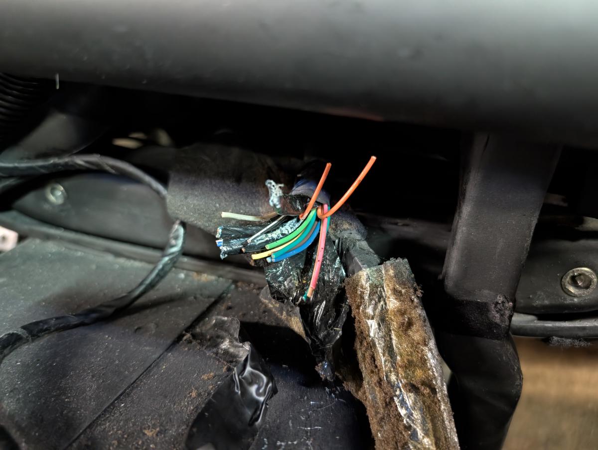 The wires from the radio connector on a C5 corvette. There's a bunch of them, but one of the two orange ones pictured will have 12v constant. You'll want to test to confirm which one it is though.