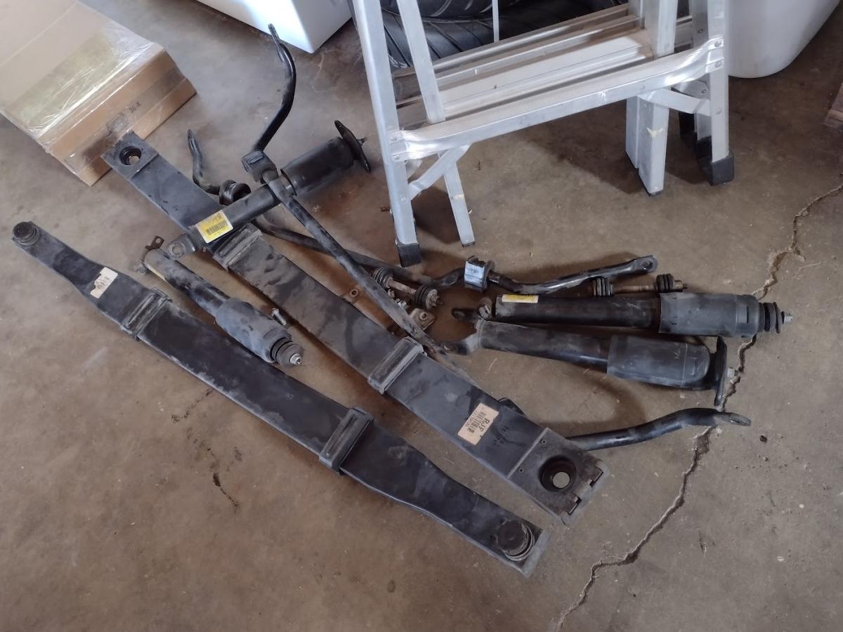 A pile of the stock suspension off of a 1999 c5 corvette