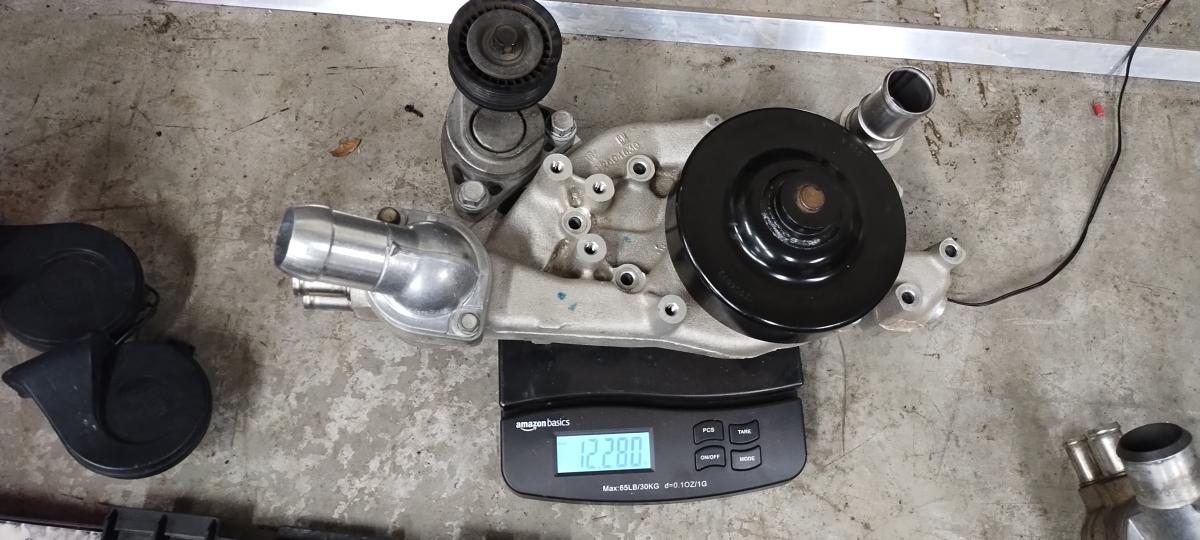 LS3 water pump with pulley and thermostat and thermostat housing weighed, coming in a 12.28lbs.