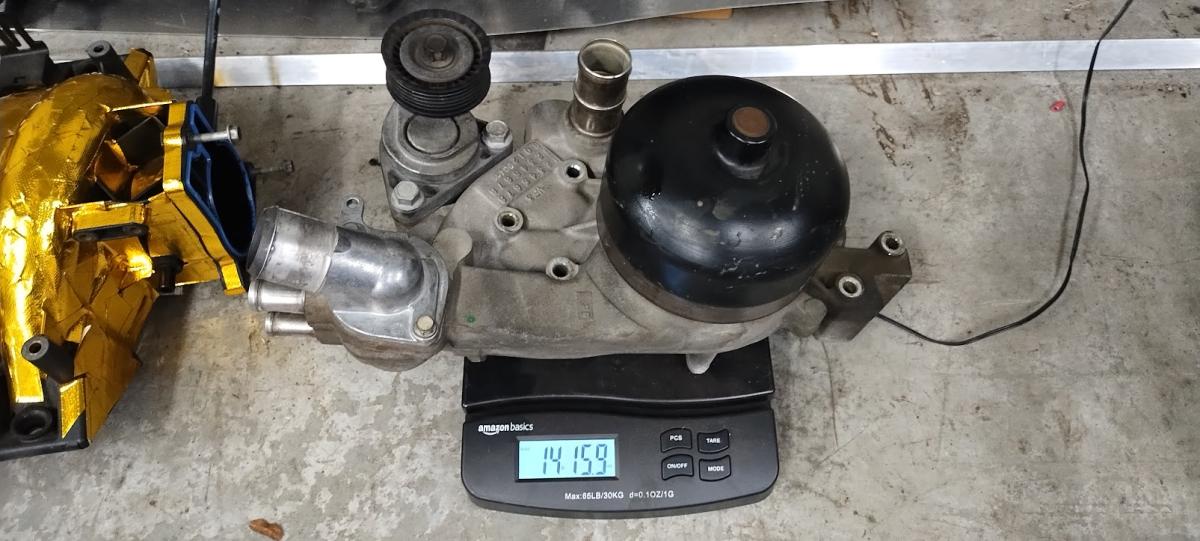 An LS1 water pump with pulley and thermostat, weighing in at 14lbs and 15.9ozs, so pretty much 15lbs.