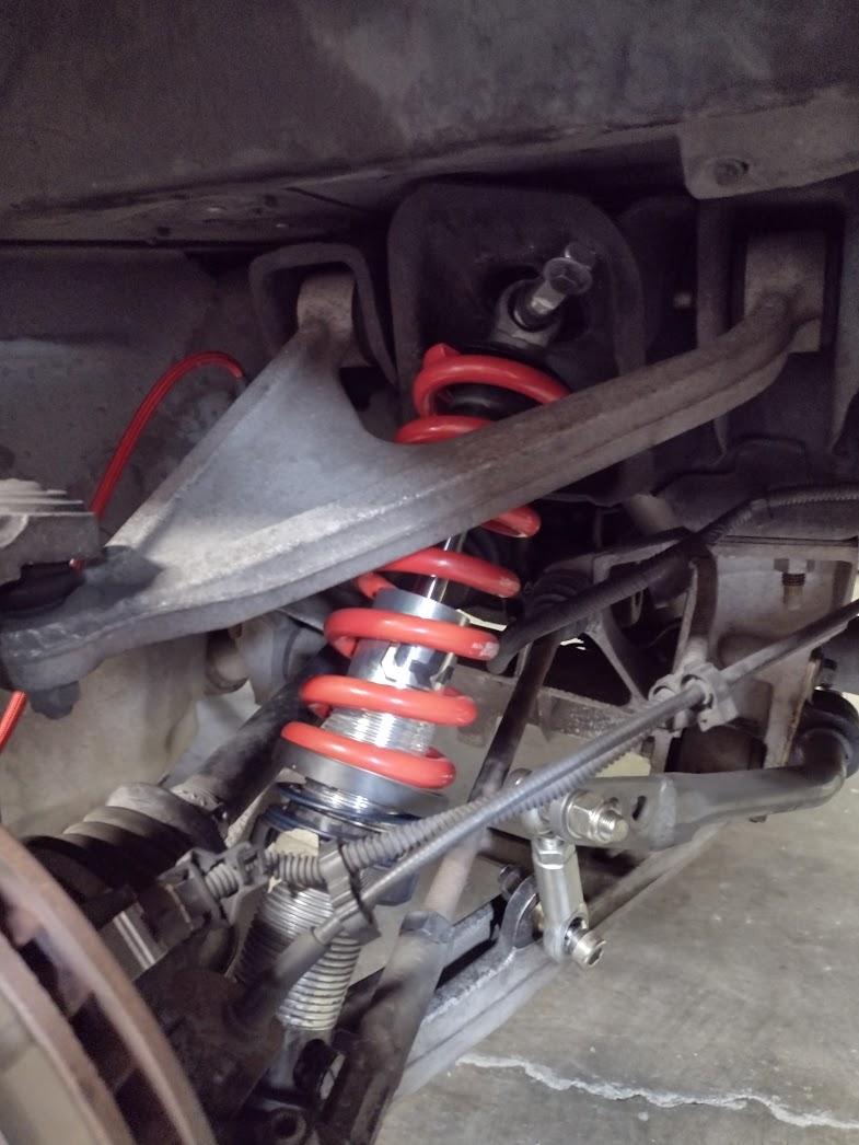 A QA1 Proma Star coilover installed in the rear of a C5 Corvette with Eibach springs.