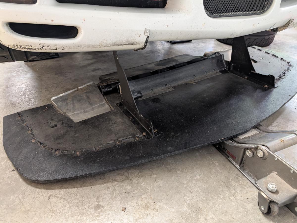 9 Lives Racing C5 Corvette splitter dropped out of the car onto the ground.