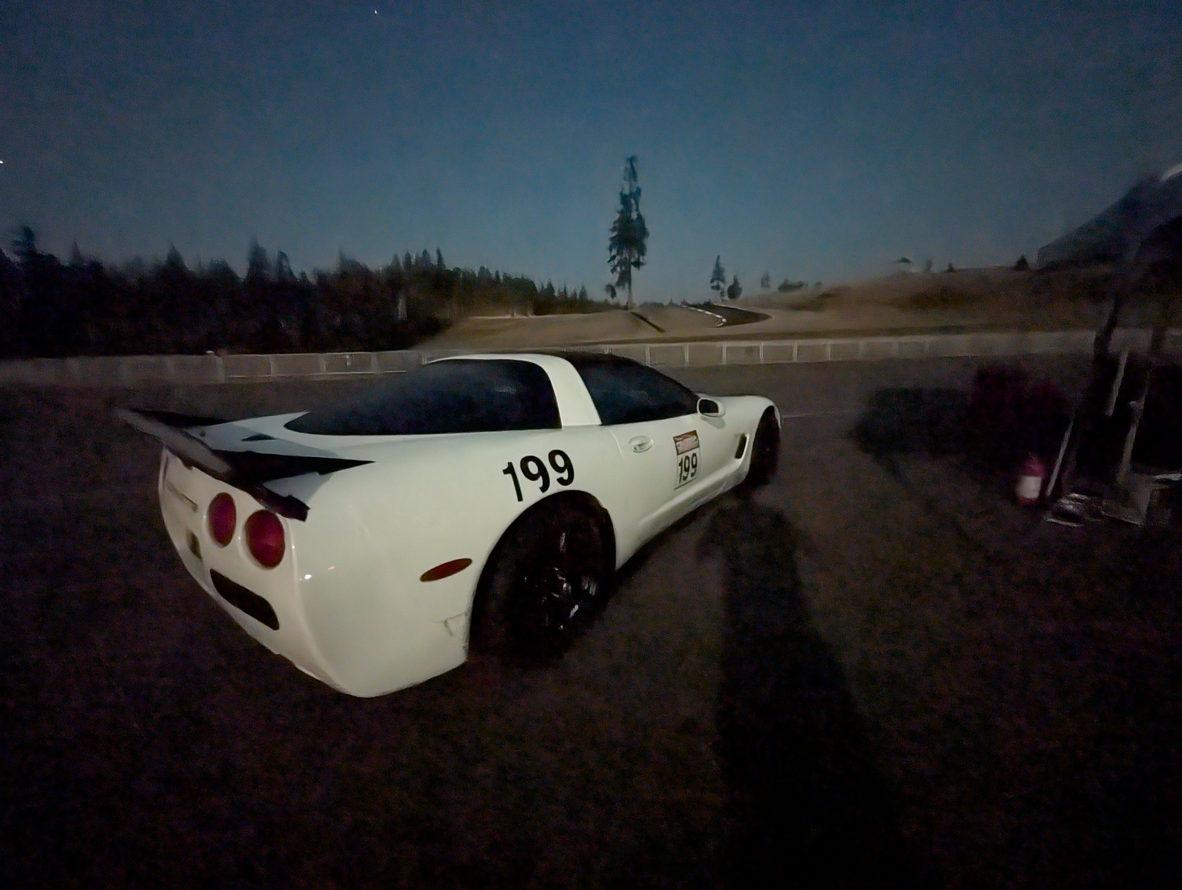 A night shot of Shred Jesse's C5 Corvette, with the Ridge Complex behind it.