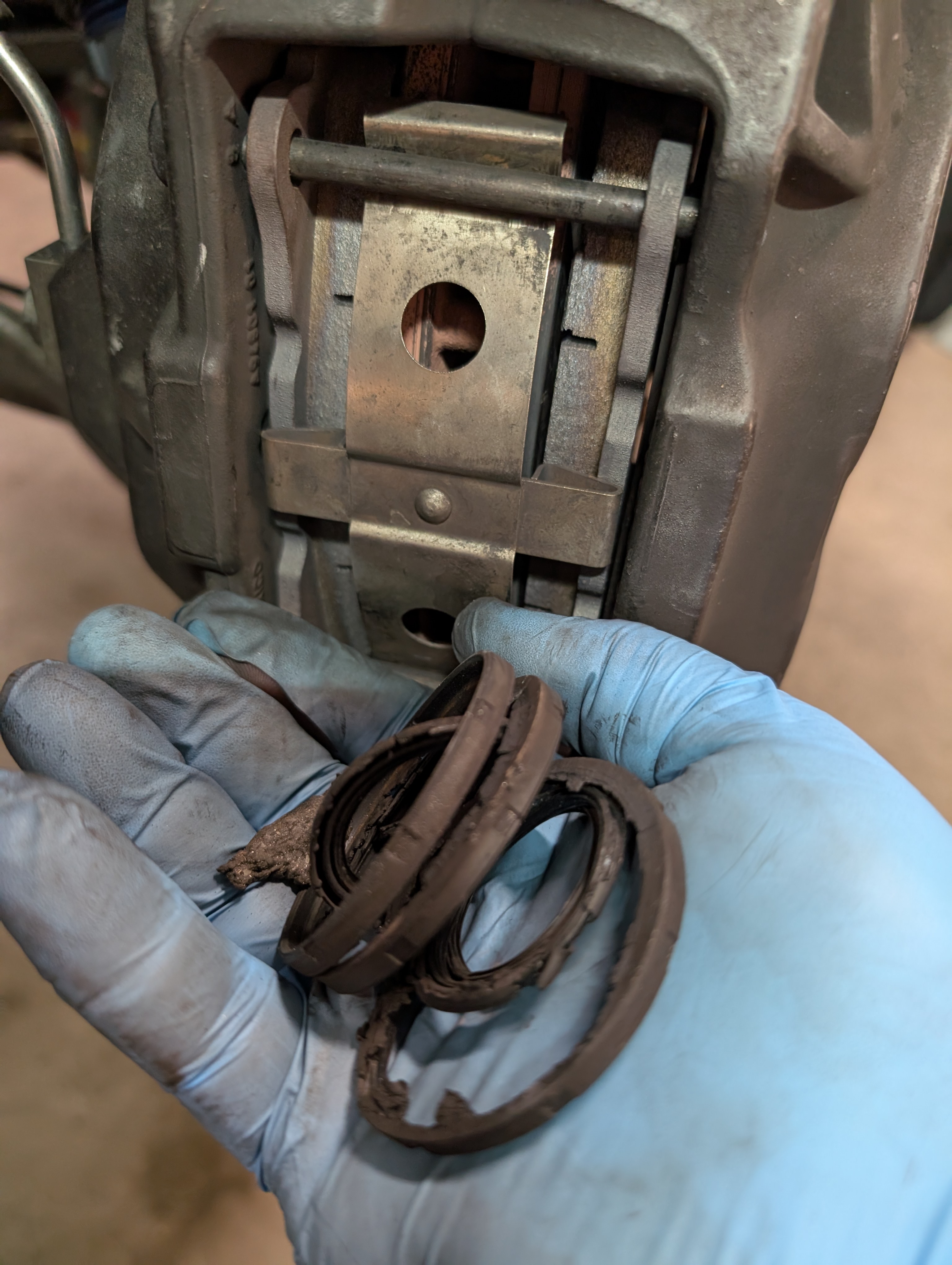 C5 corvette cadillac brembos, with Jesse holding the petrified remains of the brake caliper piston rubber boots.