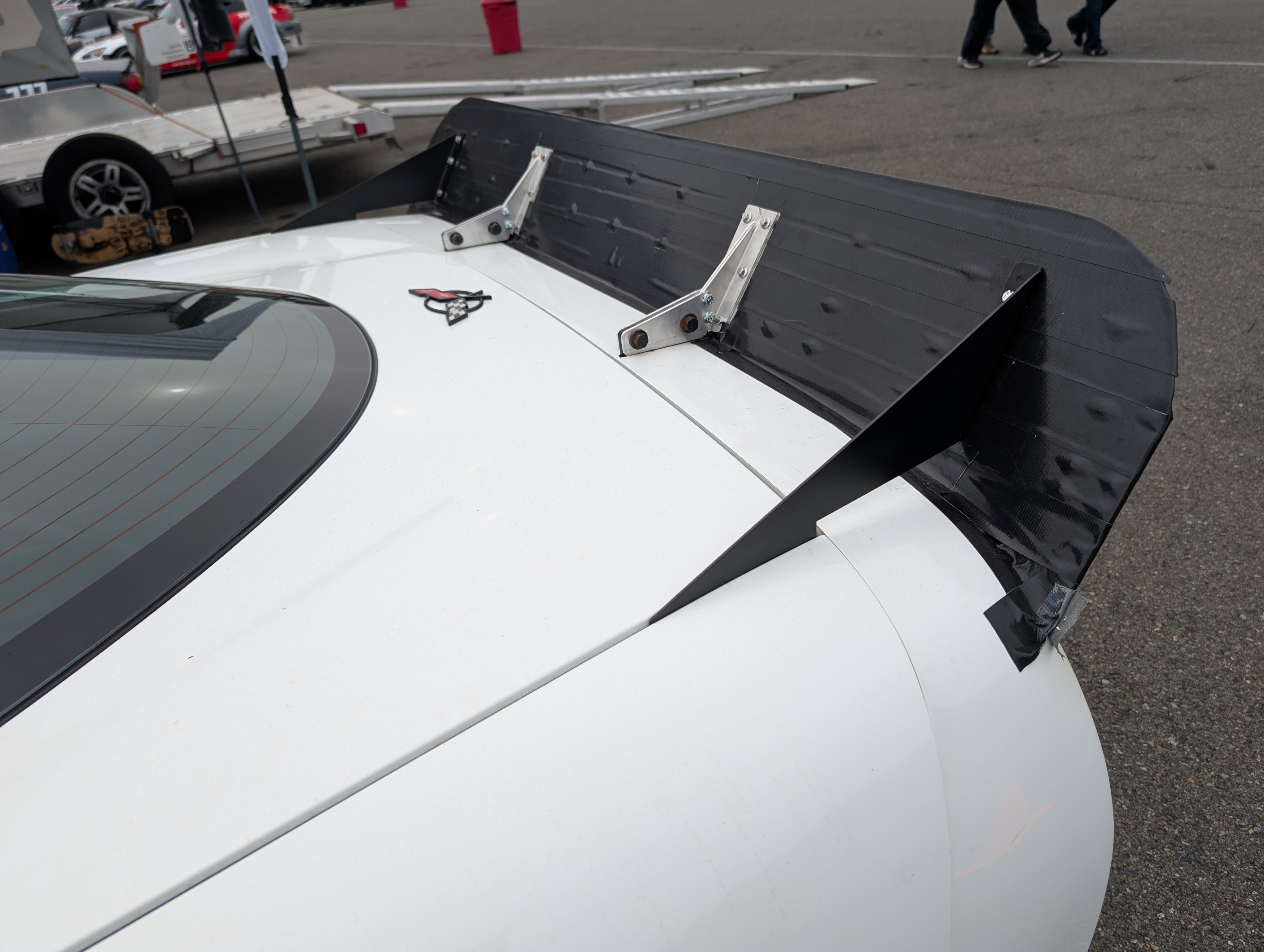 The "final" rear spoiler as used at the event. The outer brtackets are nice printed piece from SendCutSend, while the interior pieces remain bare aluminum. The entire spoiler panel is now also covered in black gorilla tape.
