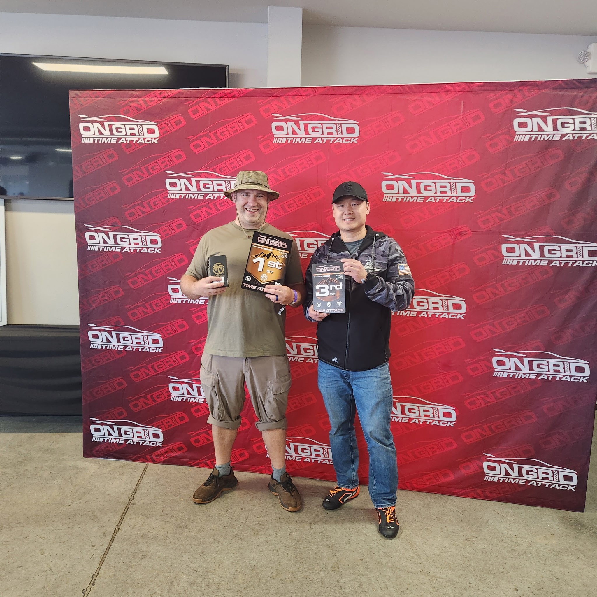 Jesse and another person posing to show off their awards for getting first and third. Jesse took first place.