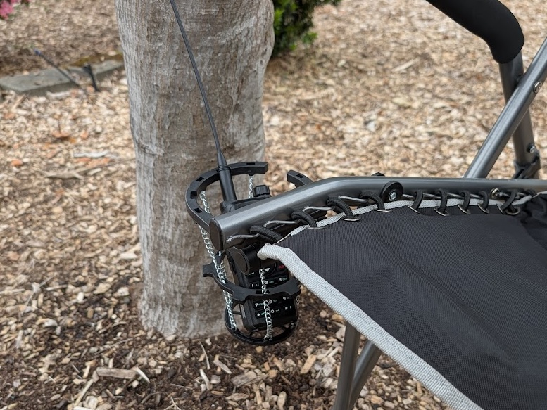 a Baofeng UV-28R in a large camp chair cup holder.