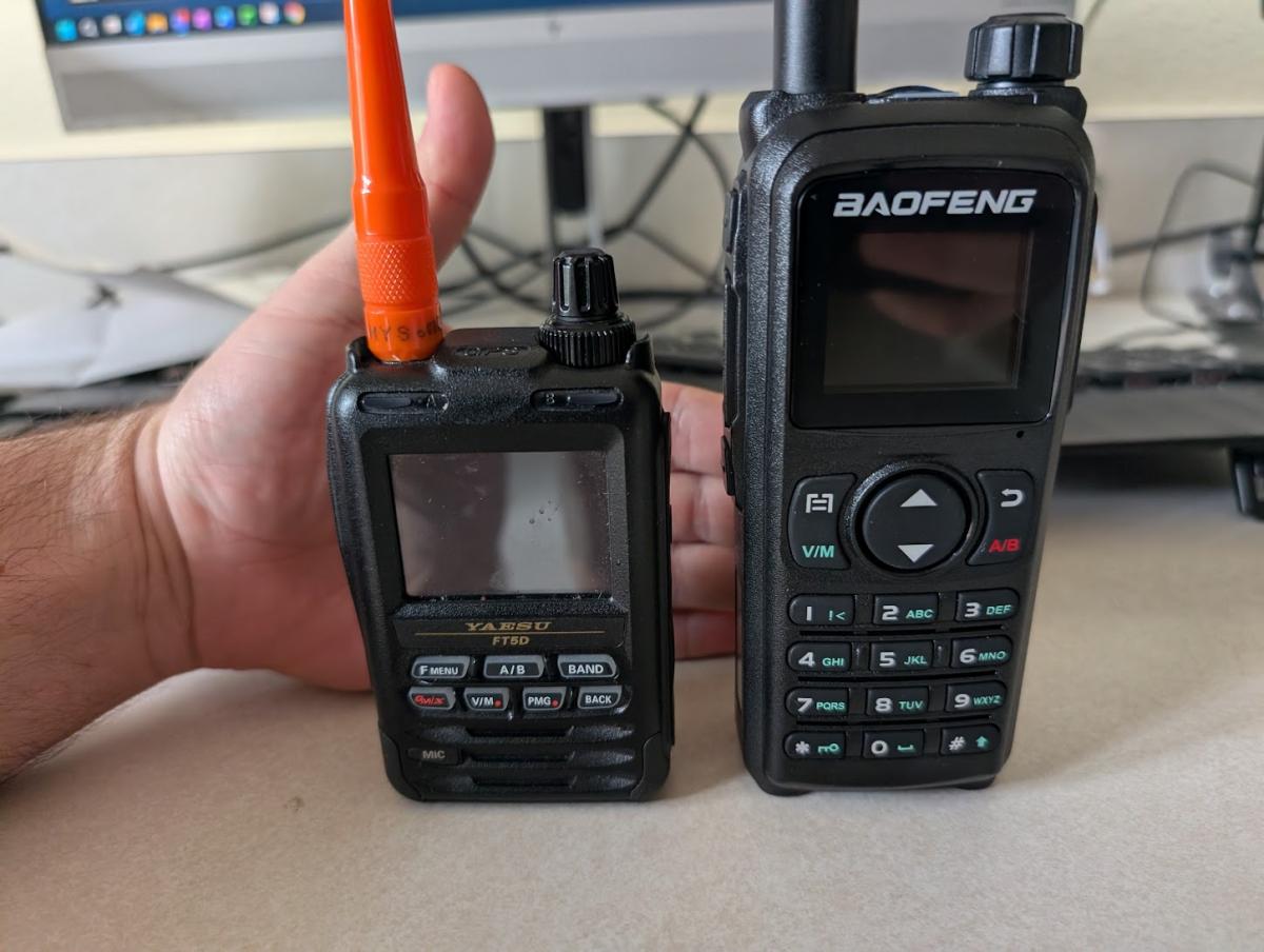 A picture of the Yaesu FT5DR next to the Baofeng UV-28+, demonstrating that the UV28+ is nearly double the size of that radio as well