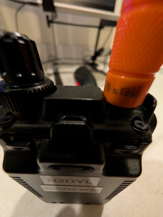 A picture of the top of the Yaesu FT5DR, demonstrating how it has a relief cut out for the knobs, but not for the Antenna