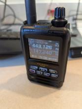 A Yaesu FT-5DR handheld HAM radio showing some frequencies and channel information