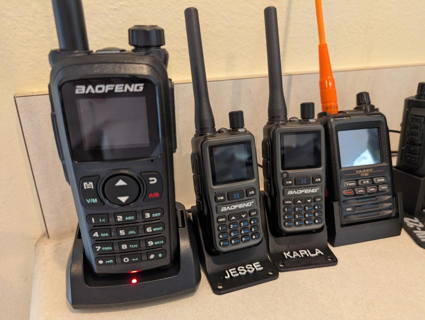 A Baofeng UV-28+ pictured on the left, next to 2x Baofeng UV-5R mini's and a Yaesu FT5DR