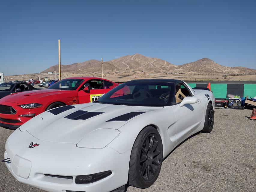 White C5 Corvette parked by the wall at Streets of Willow
