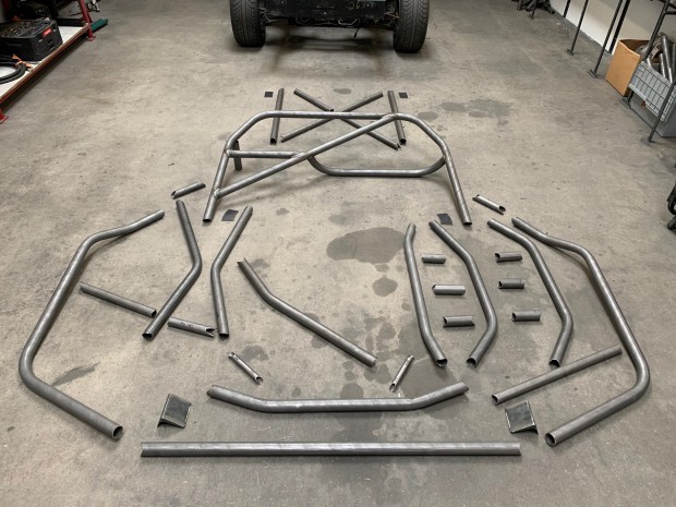 The Trackspec C5 Corvette roll cage laid out on the floor. This is the kit with the X-bar setup.