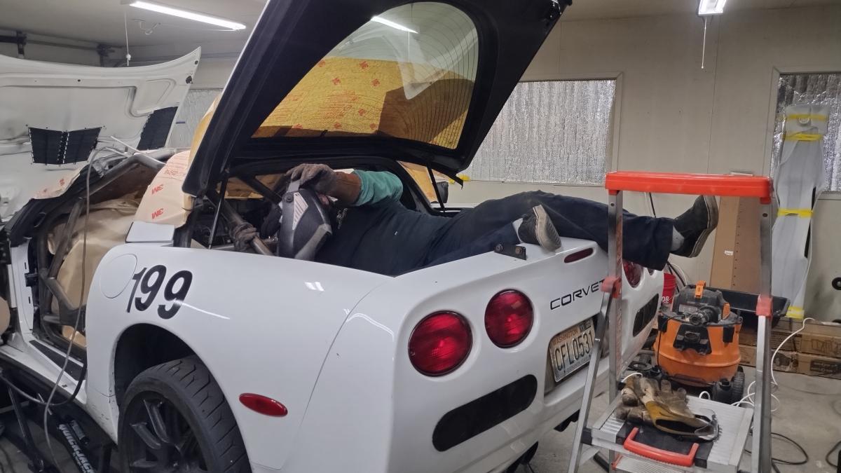 Dave aka groundscore sprawled into the rear of the Corvette to allow access to hard to reach locations for welding on the C5 Corvette Trackspec Rollcage
