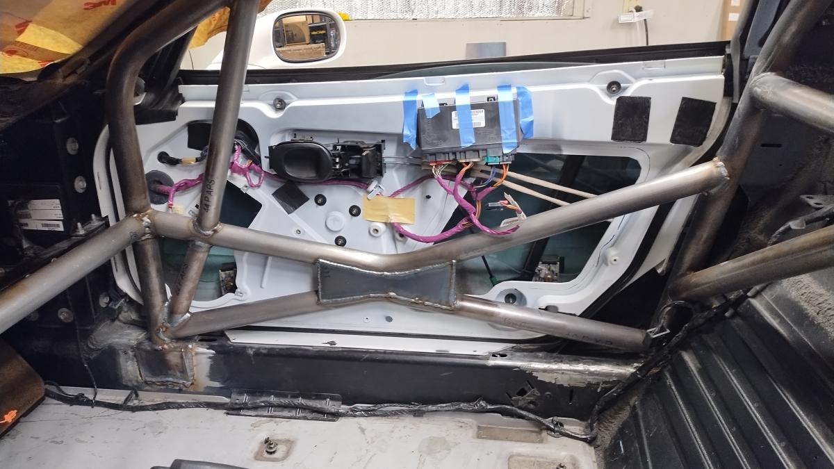 The passenger side door closed on the C5 corvette with Trackspec roll cage, demonstrating how the notched door allows closing the car up.