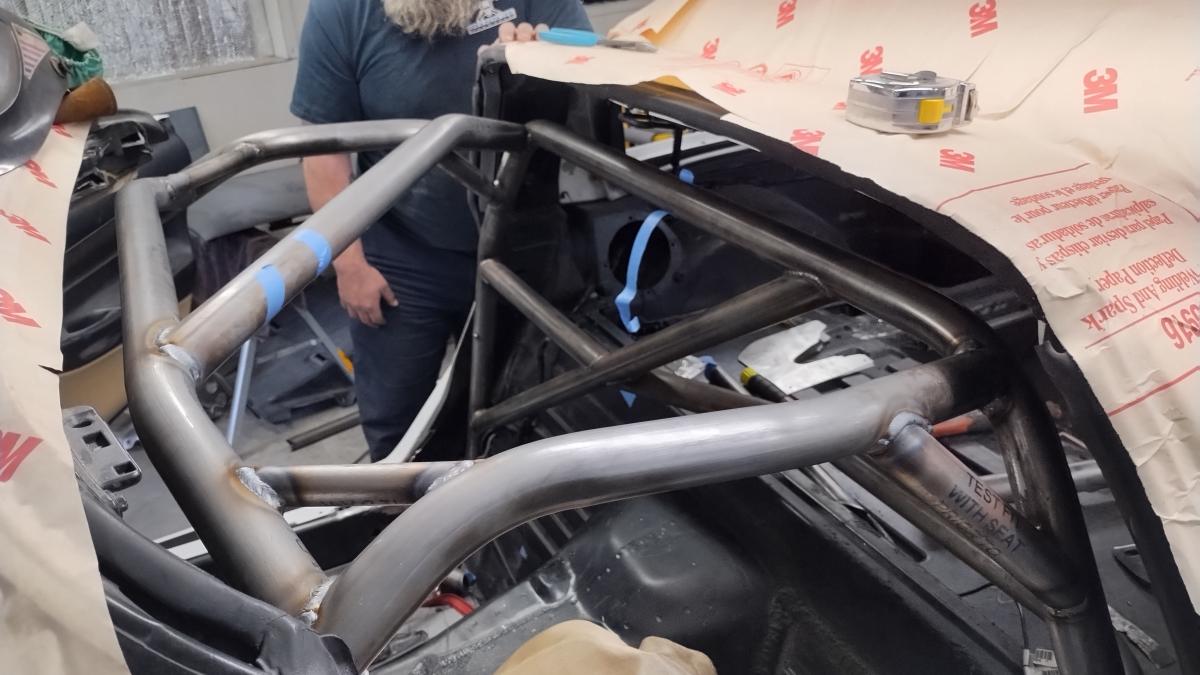 A dropped down into the frame front section of a C5 Corvette Trackspec roll cage, as done to allow welding over the tops of all the joints.