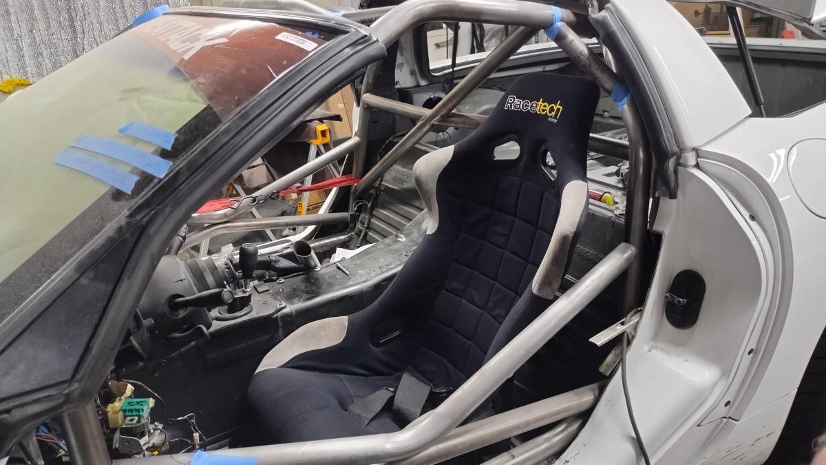 A view of test fitting the seat into a C5 Corvette with a tacked in front half of the Trackspec C5 Corvette roll cage