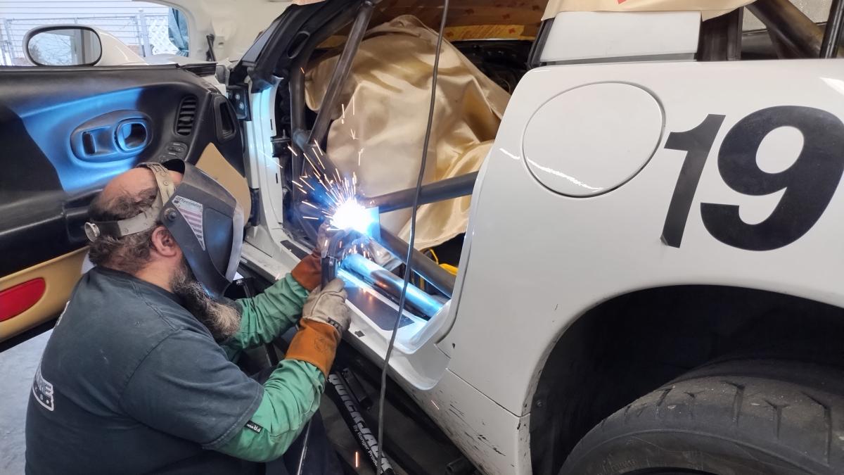 Dave aka Groundscore welding in the door bar "box" or "bowtie" on the C5 Corvette Trackspec roll cage for tieing the two bars together into a solid door X bar