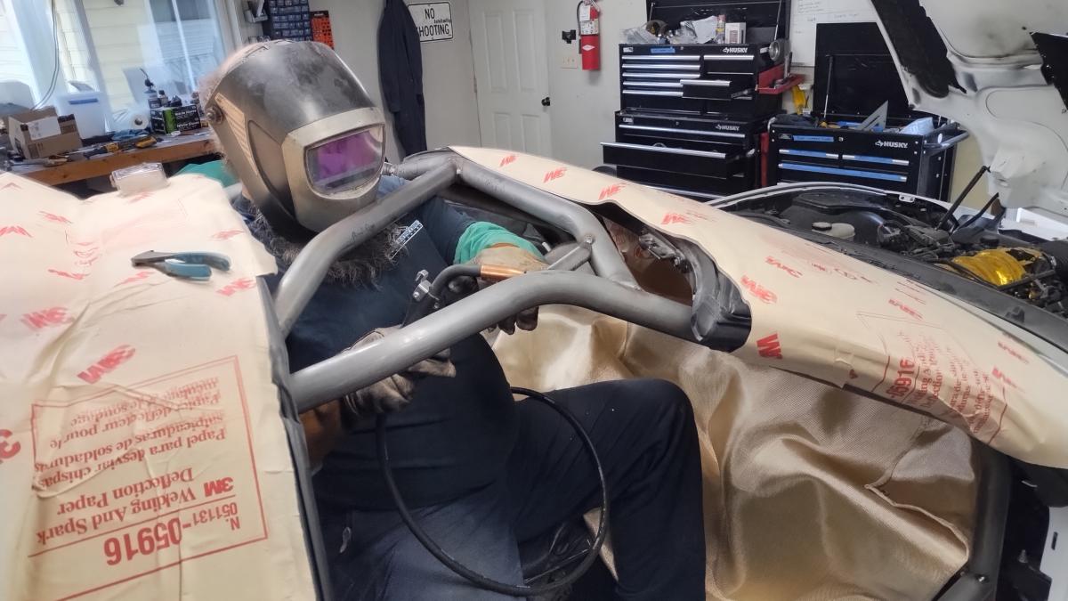 Dave aka ground score welding in the front roof crossbar on the C5 Corvette Trackspec Rollcage