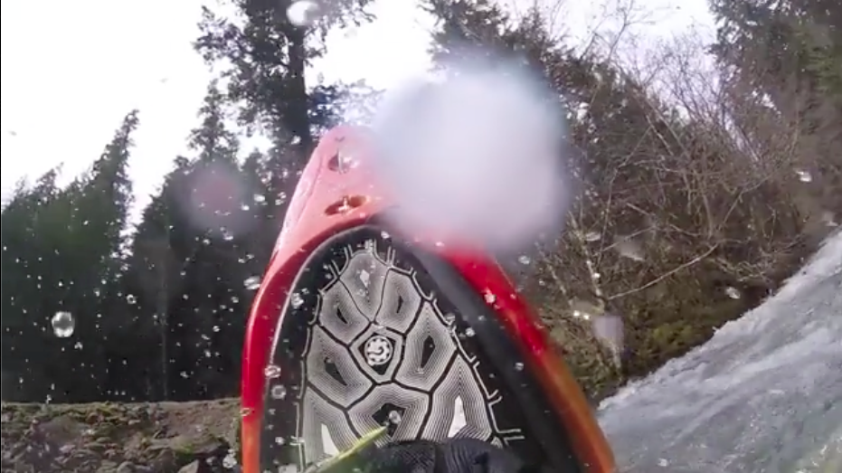 A shot of the deck of Jesse's Antix 1 kayak mid stern squirt. The view is of the sky.